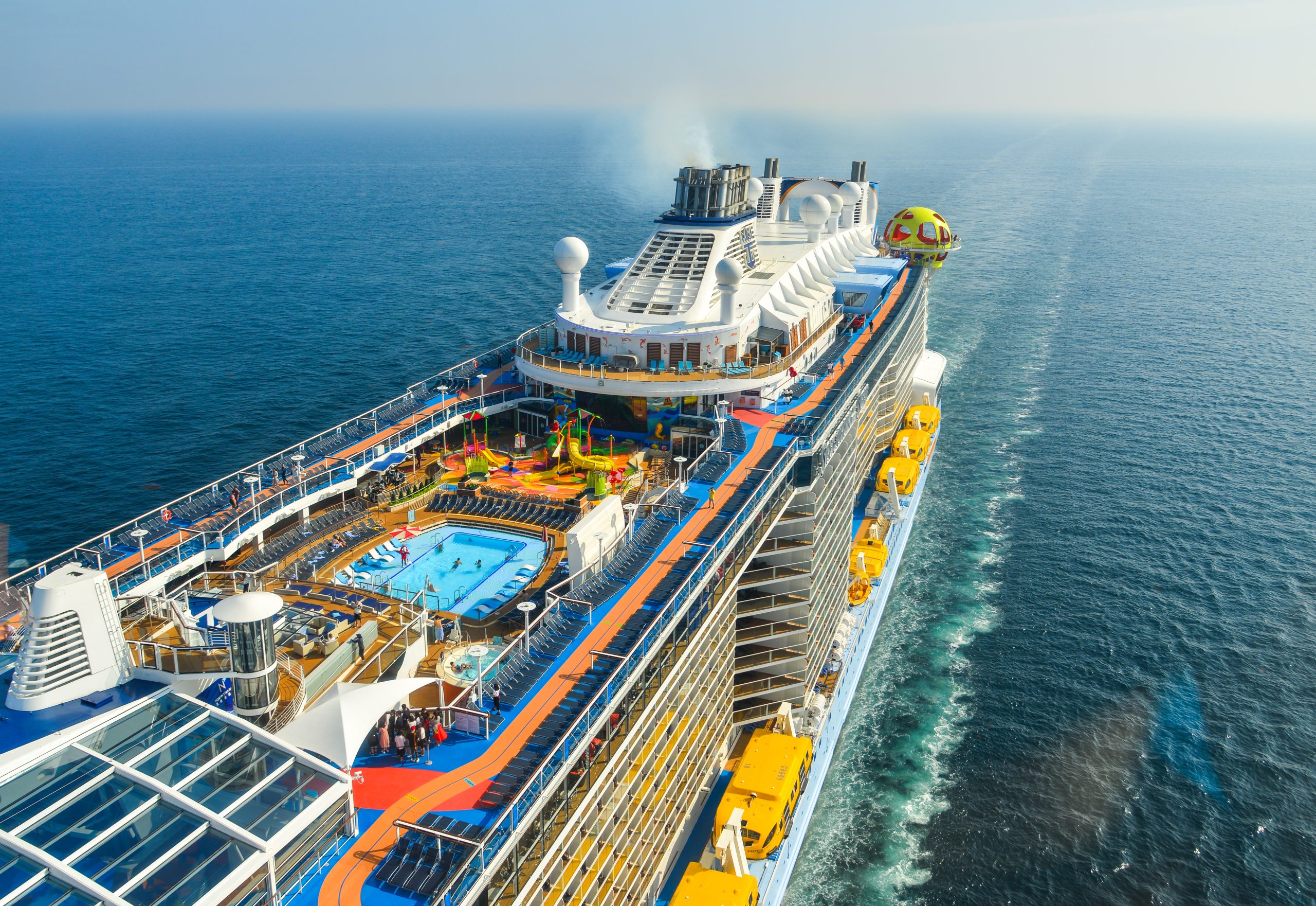 Aerial shot of a cruise ship sailing in the ocean.